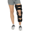 Person wearing the Vive Health ROM Knee Brace, demonstrating its secure fit and comfort for daily mobility support, Moovkart