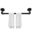 Industrial-style towel bar with two white towels hanging