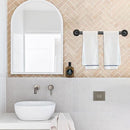 Modern bathroom with a mirror, sink, and towel rack